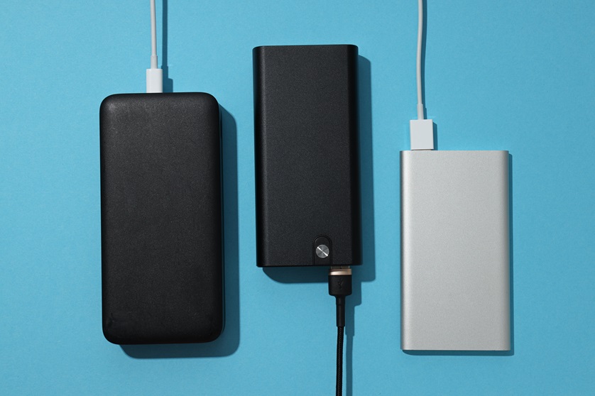 Powerbanks,And,Cords,On,Blue,Background,,Top,View